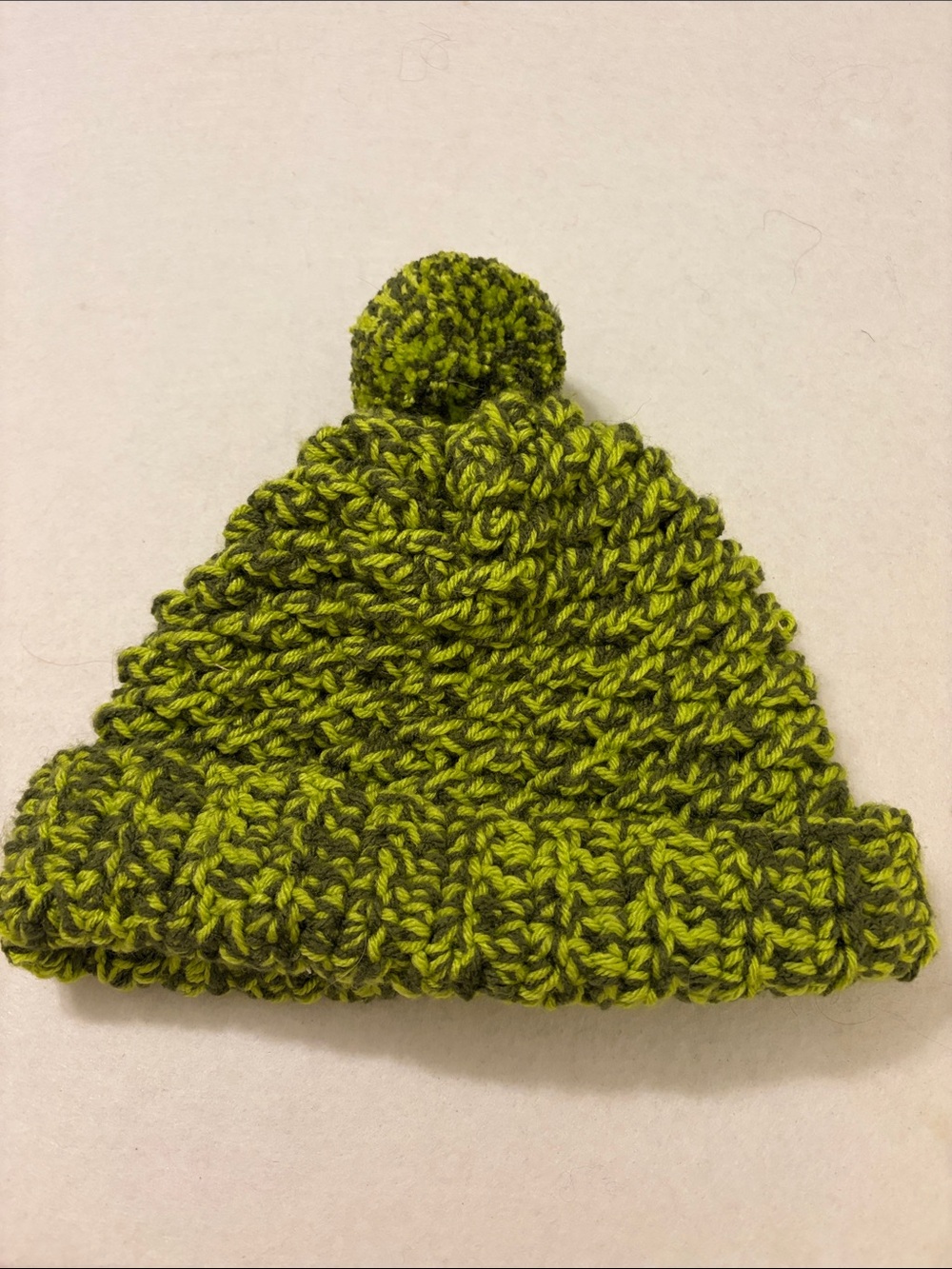 Handmade green beanie with pom-pom